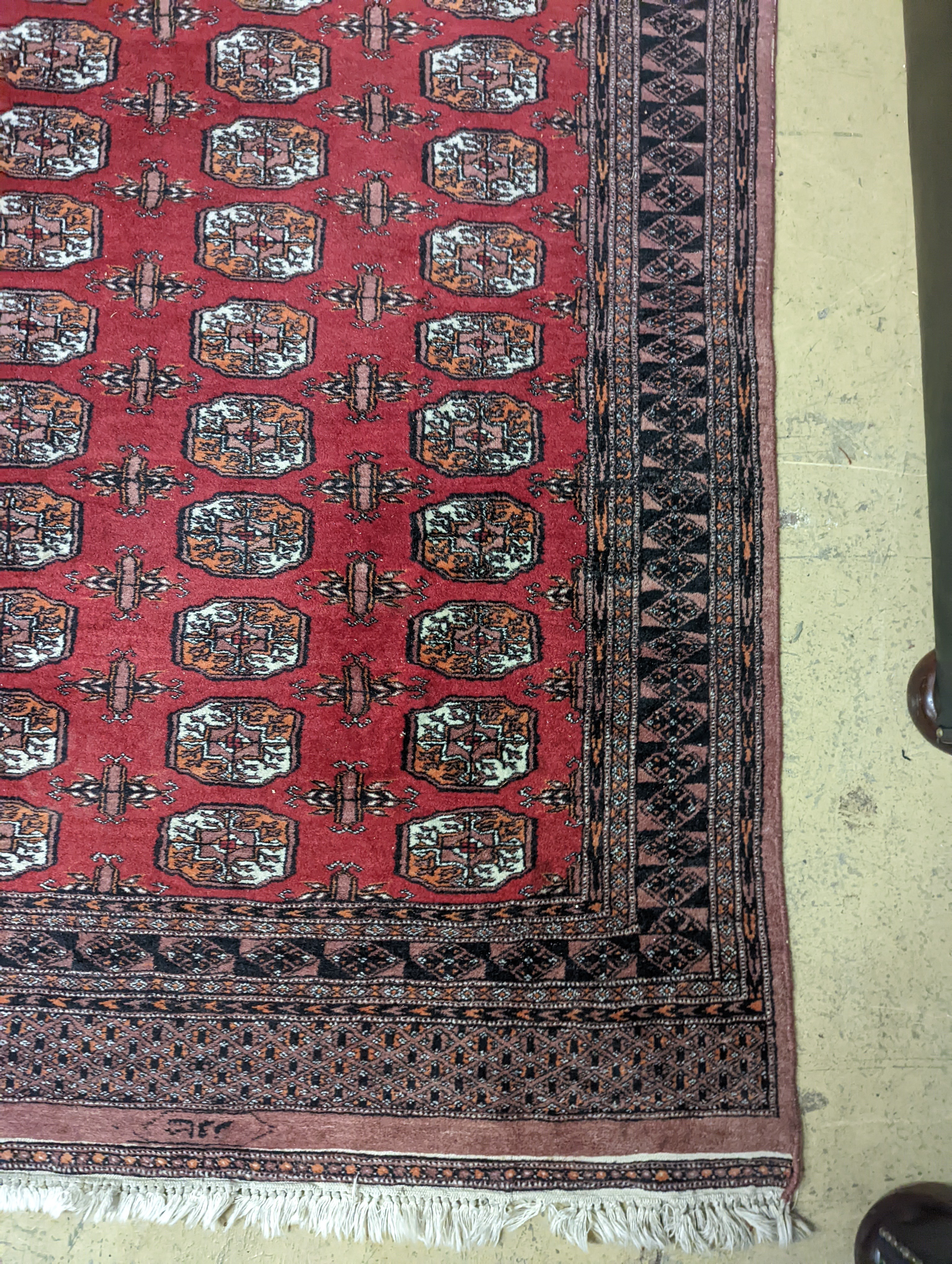 A Bokhara red ground rug, 196 x 126cm